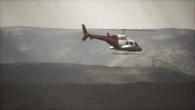 extreme slow motion flying helicopter near mountains with fog
