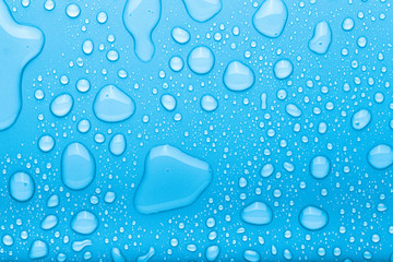 Drops of water on a color background. Selective focus. Blue