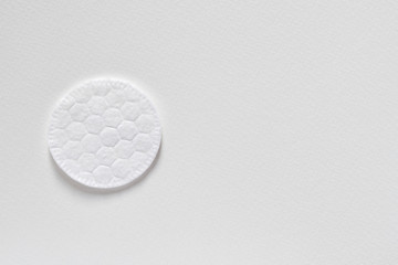 Cotton sponge or cotton cosmetic pad on the light background. Closeup, top view