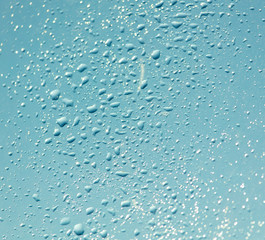 Drops of water on a blue glass window