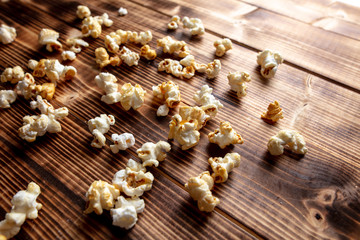 Fototapeta na wymiar Popcorn flakes on a wooden background
