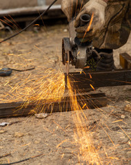 Sparks from sawing metal at a construction site