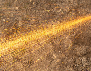 Sparks from sawing metal at a construction site