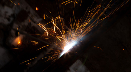 sparks from metal welding at a construction site