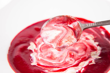 Beetroot cream soup, with yoghurt and sunflower seeds mixed in, eaten with a vintage spoon