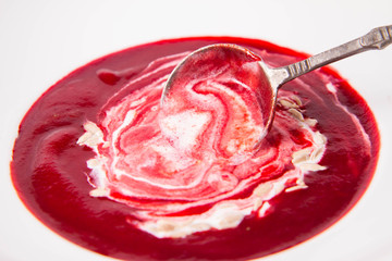 Beetroot cream soup, with yoghurt and sunflower seeds mixed in, eaten with a vintage spoon