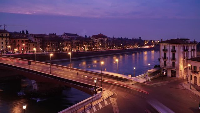 Timelapse of Verona small Italian city town in Italy with view of historical house building bridge people on street with panoramic cityscape traffic and sunset for holiday vacation in winter summer 