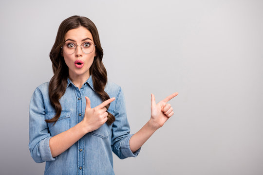 Photo of funny pretty business lady open mouth indicate fingers empty space advising cool low prices shopping wear specs casual jeans denim shirt isolated grey color background
