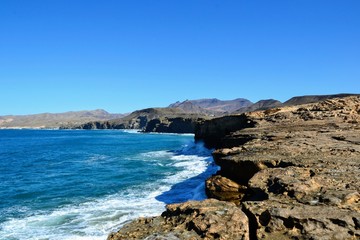 Rocks formation near La Pared beach on the western coast of Fuerteventura, Canary Islands, Spain. Popular spot for surfers. The wild coast of Playa La Pared
