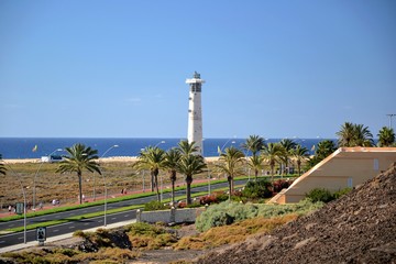 Fototapeta na wymiar Picuresque view on Morro Jable Lighthouse on the Morro Jable beach on Jandia peninsula. Atlantic Ocean Fuerteventura, Canary Islands, Spain