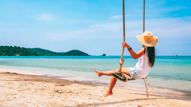 Woman On Swing In Beach