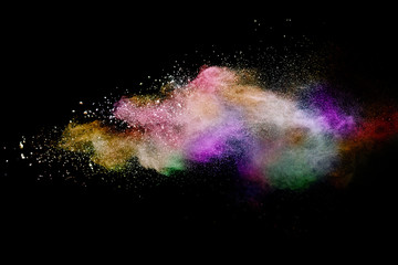 Abstract powder splatted background. Colorful powder explosion on black background. Colored cloud....