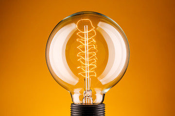 Retro lamp on a yellow background. The concept of electricity.