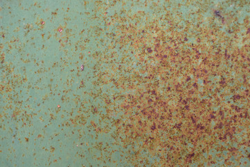 Old metal surface that has rust, corrosion, peeling of paint due to old age