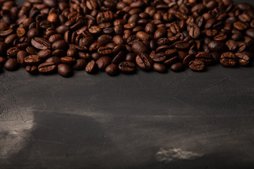 Composition with a coffee beans on a textured plastered background with a variety of arbitrary stains
