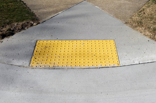 Sidewalk Curb Ramp With Bumpy Anti Slip Pad.