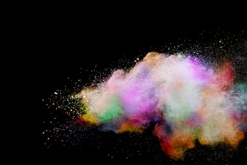 Abstract powder splatted background. Colorful powder explosion on black background. Colored cloud....