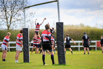 Rugby game line-out, framed with the rugby posts, horizontal image