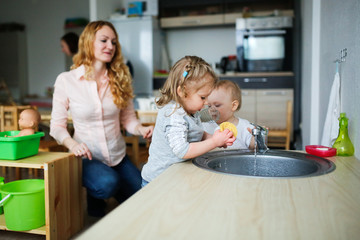 Children wash their hands in the sink
