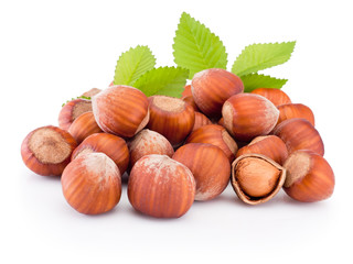 Hazelnuts with green leaves isolated on white background