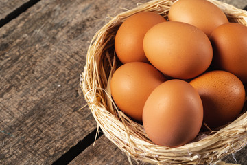 eggs in the hay nest on wooden table