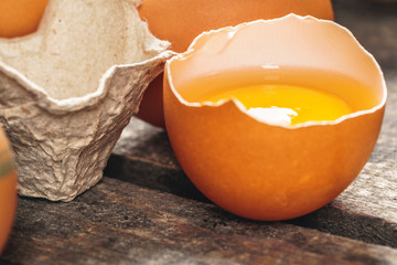 egg is half broken on wooden table