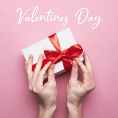 Unrecognizable Female Hands Packed Gift For Valentines Day On Pink Background With Text