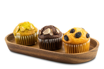 Different kind of muffins in wooden tray isolated on white background with clipping path.