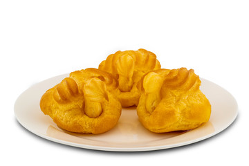 Eclairs design as duck in white ceramic plate on white background with clipping path.