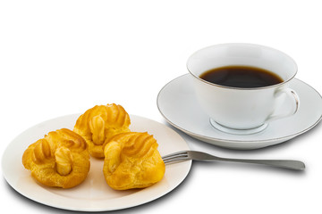 Eclairs in a white ceramic plate with metal folk and a cup of black coffee on white background with clipping path.