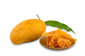 Pile of dehydrated mango in wooden plate and ripe mango with green leaf