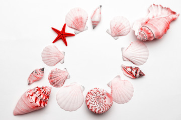 Summer holiday poster with Living Coral color sea shells and starfish on white background, copy space. Top view travel or vacation concept. Flat lay