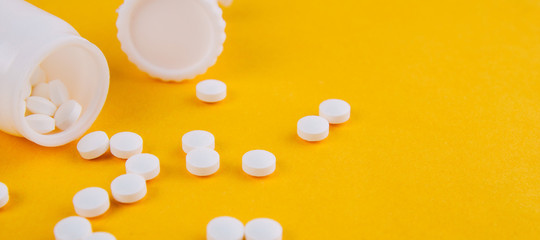 White tablets on a yellow background. Copy space for text or disign