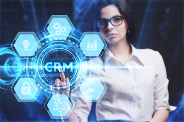 Business, Technology, Internet and network concept. Young businessman working on a virtual screen of the future and sees the inscription: CRM