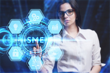 Business, Technology, Internet and network concept. Young businessman working on a virtual screen of the future and sees the inscription: SME