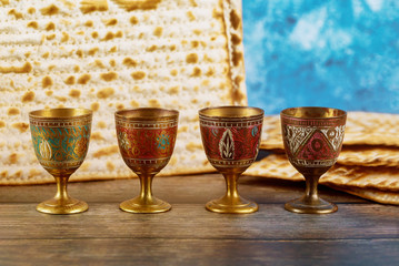 Four wine cups with matzah. Jewish holidays Passover.