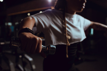 Selective focus of african american woman holding dumbbell