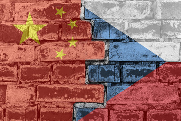 Chinese and Czech flag against a brick wall