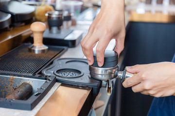 Close up of Barista hand making coffee on the machine