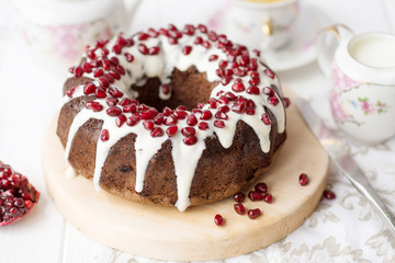 chocolate cake with pomegranate on a white table, a cozy breakfast, English tea party, chocolate dessert, a delicious cake with pomegranate, a photo of sweet food with free space for text