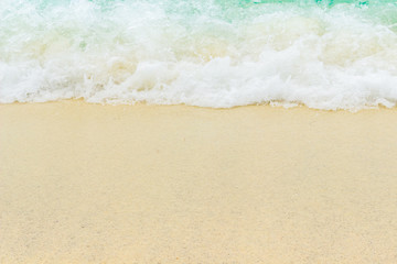 sand beach with blue wave white foamy 