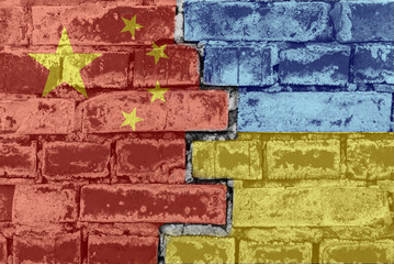 Chinese and Ukrainian flag against a brick wall