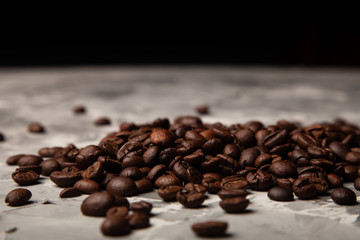 Composition with a coffee beans on a textured plastered background with a variety of arbitrary stains