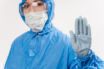 Concept of coronavirus quarantine. Concept of a global coronavirus epidemic from China. Treatment of coronavirus infection. Medic in hazmat protective suit show hands gesture for stop corona virus