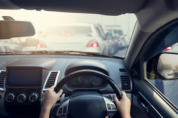 People driving inside car and many cars on the road jam in traffic junction by red light control, Rush hour in Thailand on day.