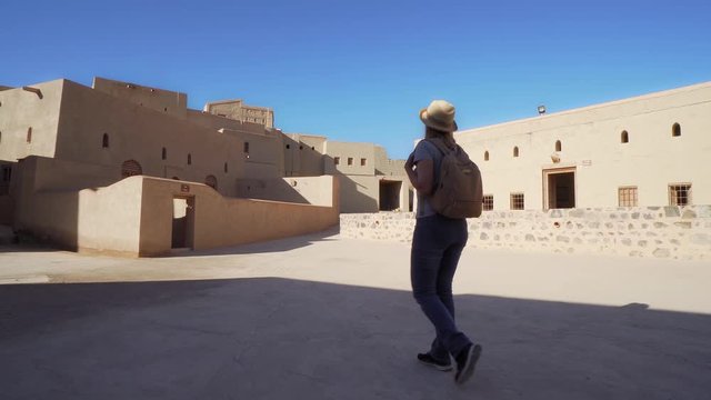 Young Foreign Female Tourist Visiting Ancient Bahla Fort in Oman