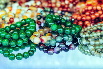 The colorful stone is used to make beautiful bracelets. Is a religious belief of Thai people that will have good luck for sale on the local market in Kanchanaburi, Thailand. Selective focus.