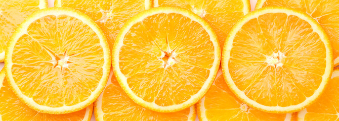 Orange fruit cut into circles background. The view of the top.