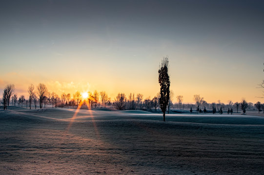 golf court in winter while sunset
