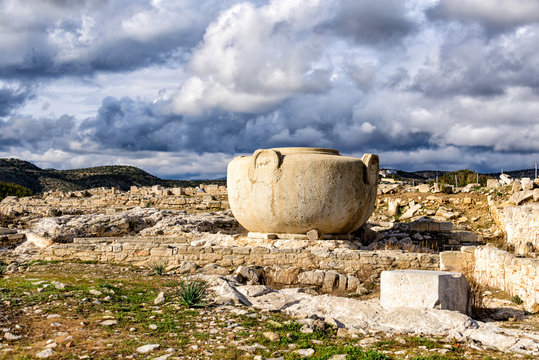 Massive stone vase in Amathus ruins, Cyprus under stormy clouds